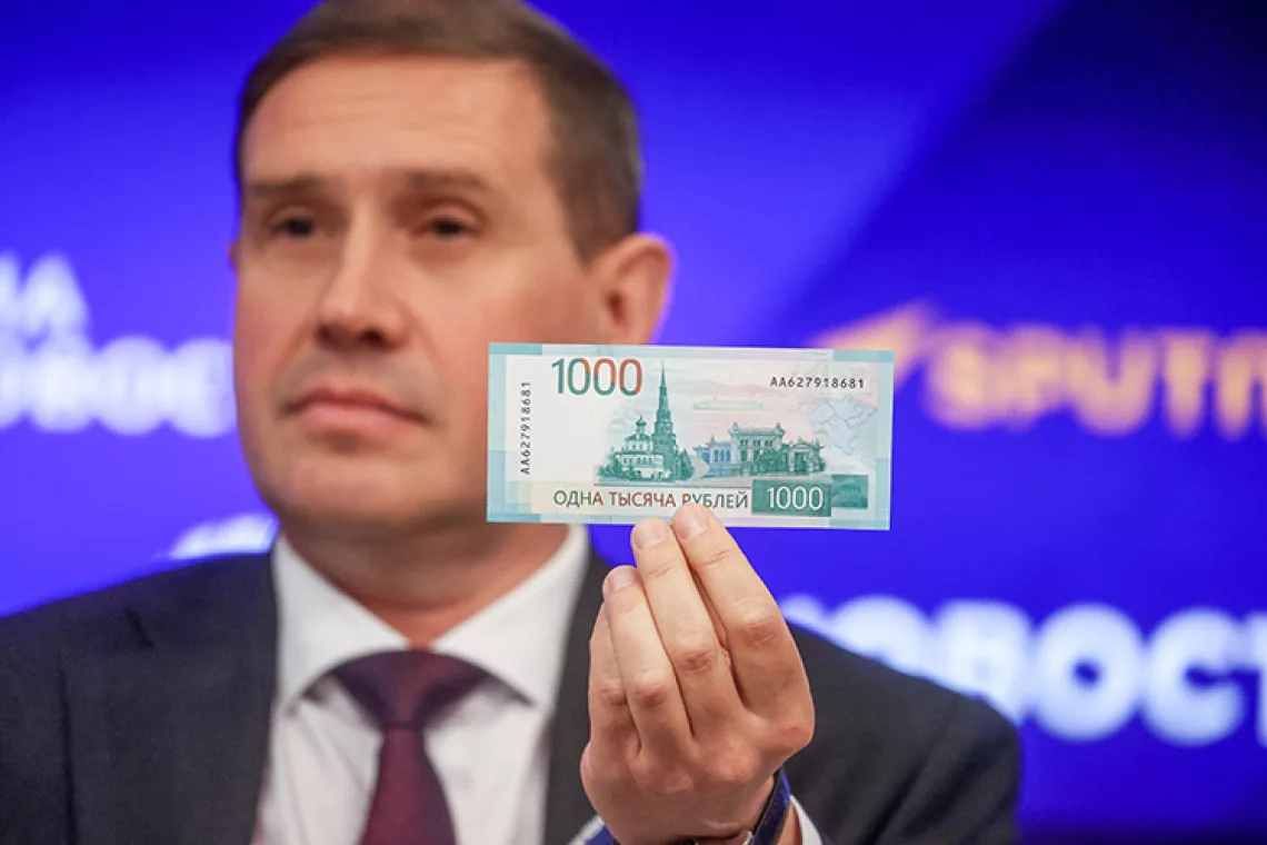 October 16, 2023. Russia, Moscow. Central Bank of Russia Deputy Governor Sergey Belov shows a banknote during the unveiling of new 1000 and 5000 Russian rouble banknotes at the 'Rossiya Segodnya' press centre.