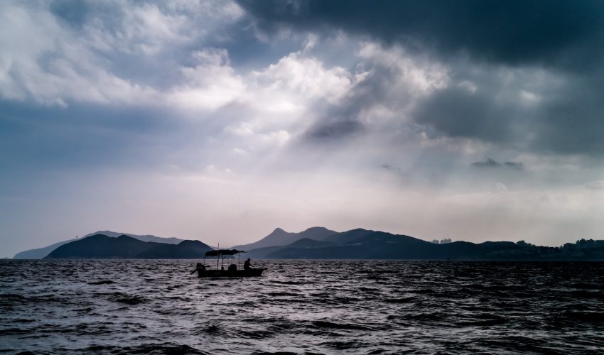 silhouette of person sailing boat during daytime