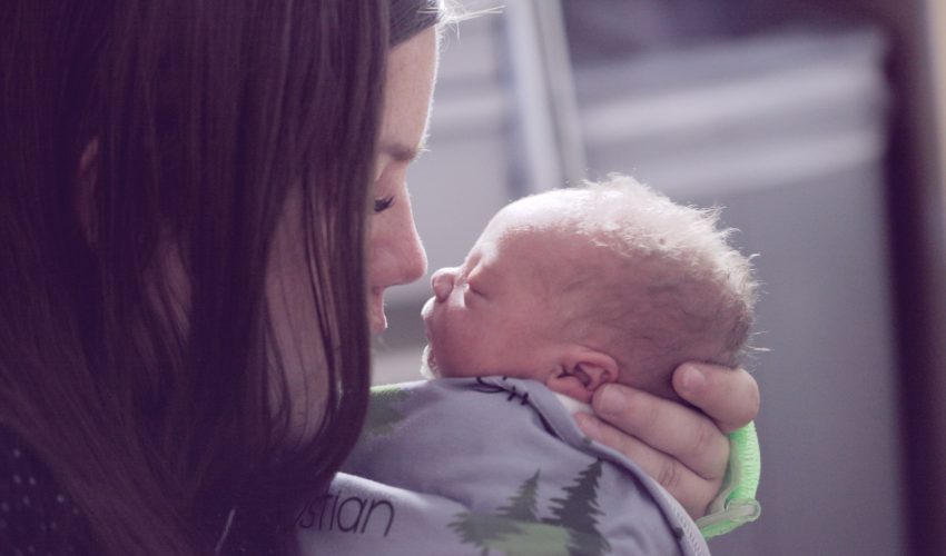 woman kissing baby